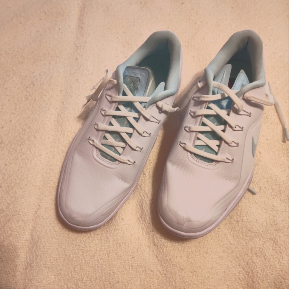 Nike Women's Size 8 golf shoes. White with aqua details.